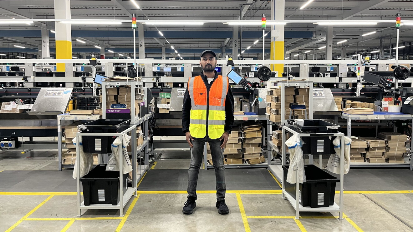 Anvesh Ejapa, Amazon Career Choice Graduate stands wearing a high vis vest with an operations background