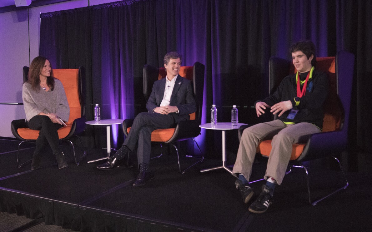 Amazon's Beth Galetti welcomes the Special Olympics' Tim Shriver, and athlete Marcia Barrett.