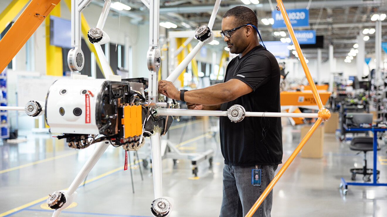 A Prime Air employee working at a drone manufacturing assembly line.