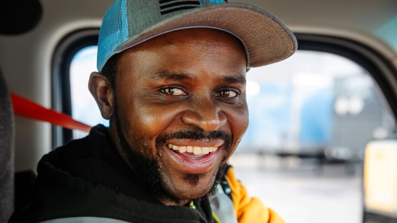 portraits and environmental photos of abel tuyisenge, a transportation operations management associate at amazon, as he drives and inspects trucks