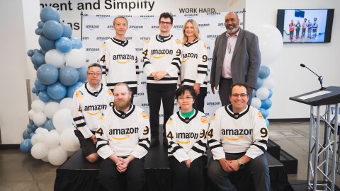 Image of eight employees wearing Amazon hockey jerseys