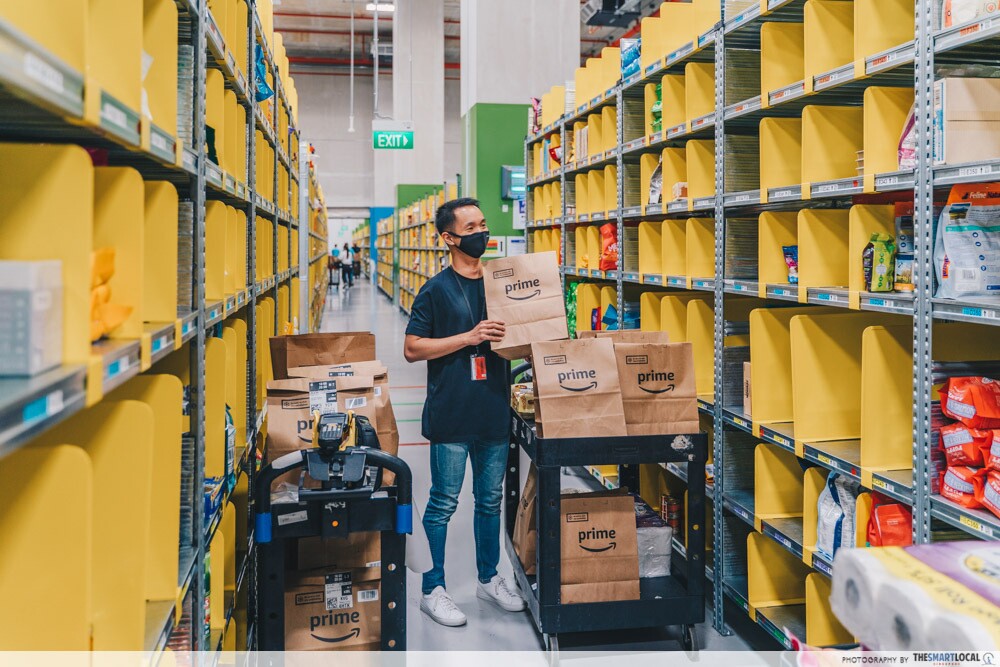 An employee packing multiple Amazon Fresh orders