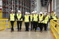Visita oficial de las autoridades locales al centro logístico de Illescas. Aparecen todos vestidos con el chaleco amarillo, las botas de seguridad y los cascos. Al fondo las estanterías vacías. A destacar: el director regional de Operaciones en España e Italia de Amazon, Fred Pattje, Nacho Ferreiro, Responsable del centro, el alcalde de Illescas, José Manuel Tofiño, y el presidente de Castilla-La Mancha, Emiliano García-Page.