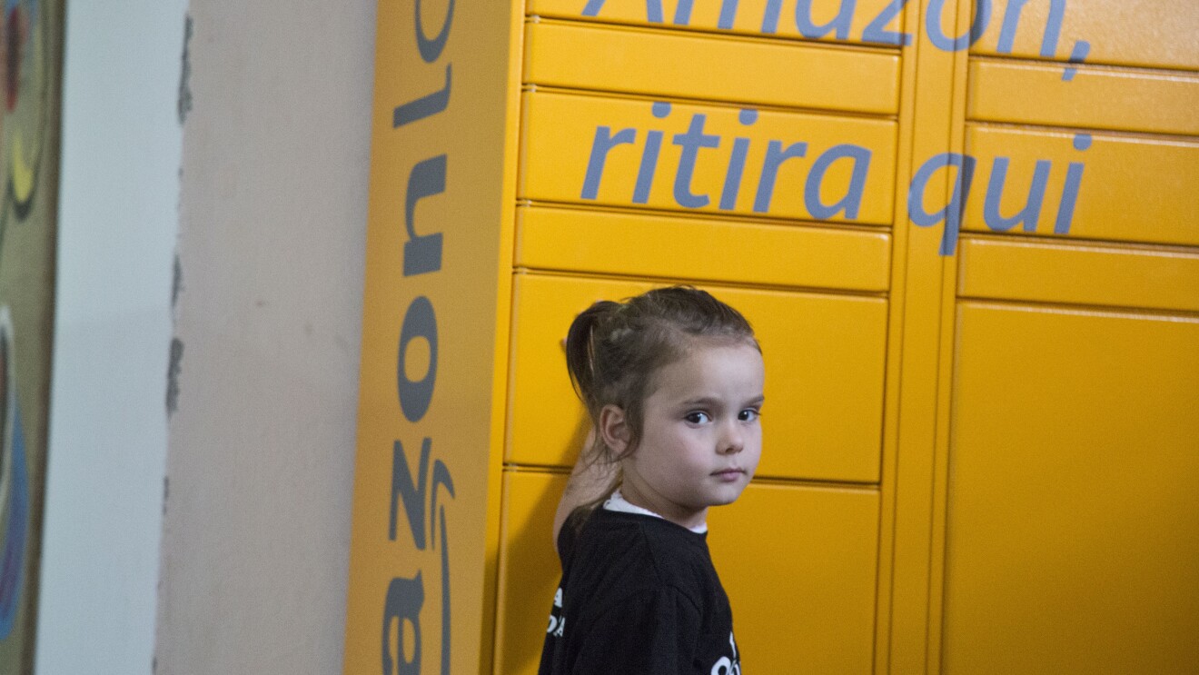 Una bambina davanti all'Amazon Locker Geremia nella Biblioteca di Scampia