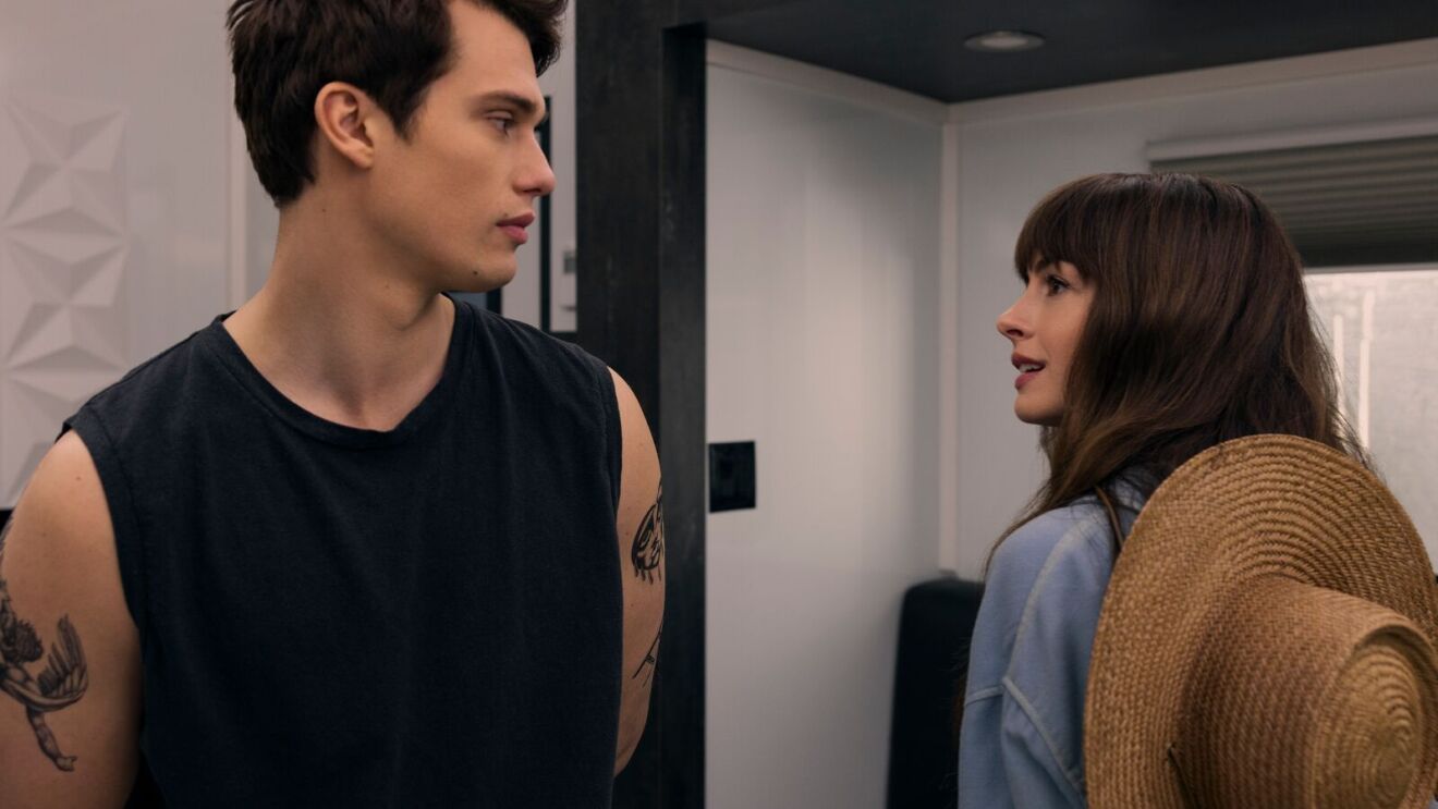 A scene from The Idea of You with Young couple in intense moment, man with arm tattoos