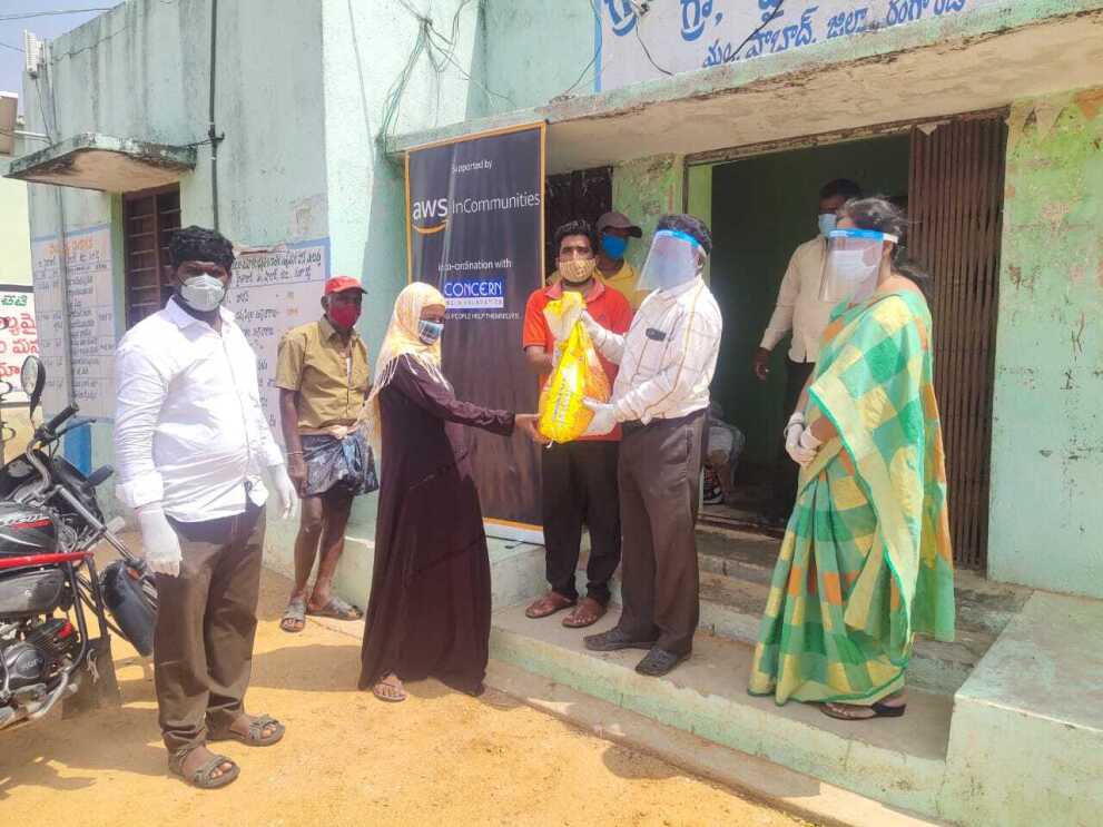 AWS in communities Telangana - a woman receiving dry ration 