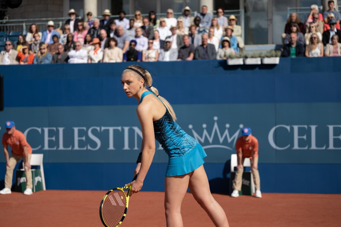 Justine on the tennis court reading to begin a game