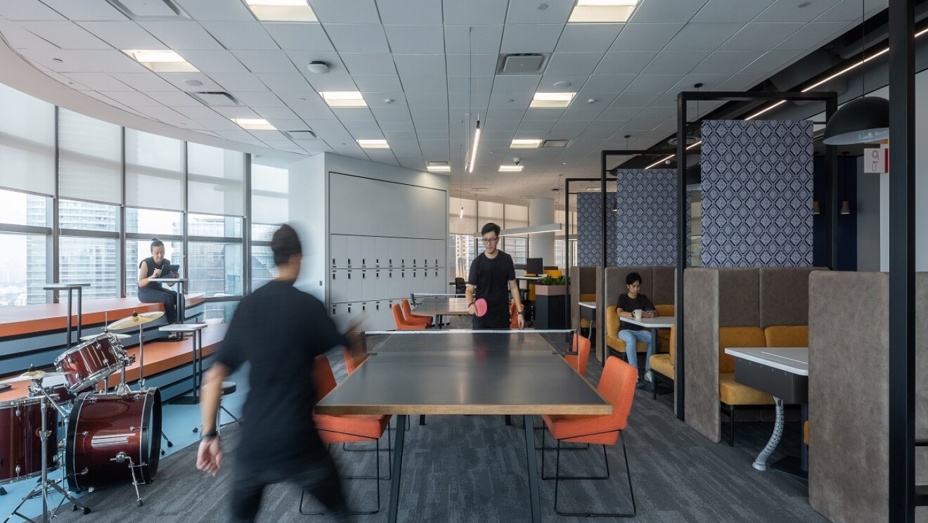 People in the space reading and playing ping pong.