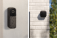 Blink doorbell with water droplets on it next to Blink Outdoor 4 camera
