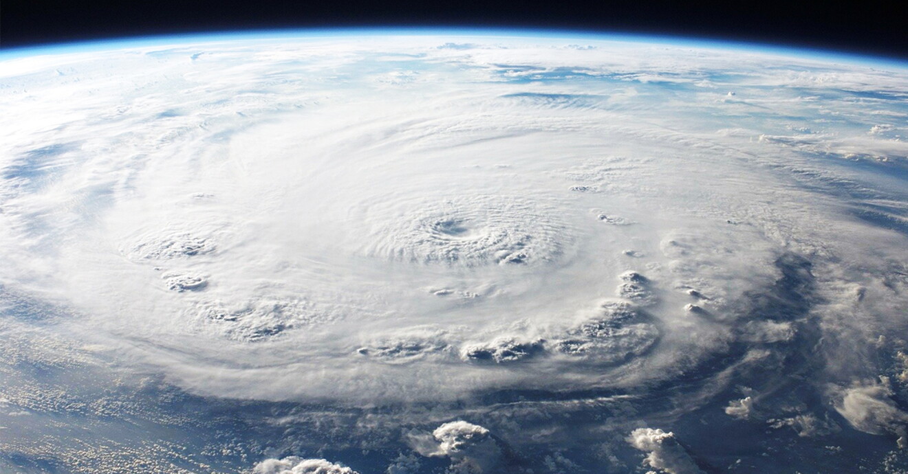 Aerial view of a hurricane swirling over the ocean.