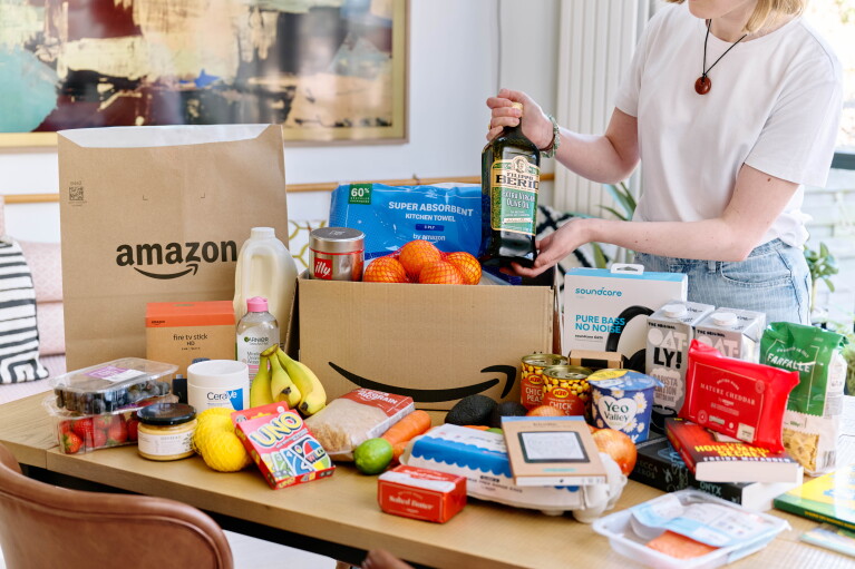 Woman standing by her Amazon grocery shop