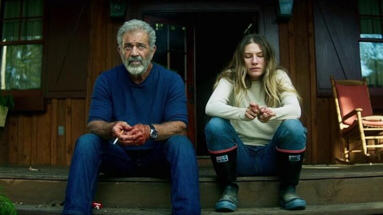 Father and daughter sit on porch steps with blood on their hands 