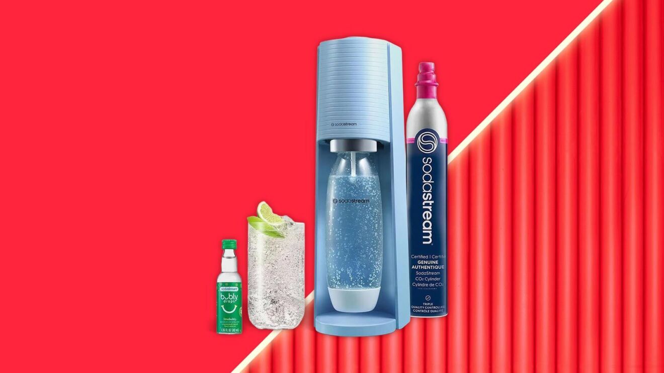 SodaStream sparkling water maker with accessories on vibrant red background