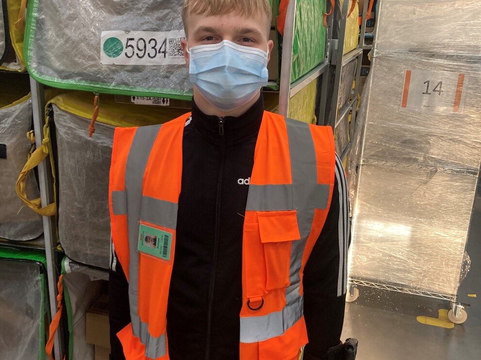 Anson Barratt – Carter, Sortation Associate at Amazon's delivery station in Sheffield, pictured wearing a high visibility vest and a face mask.