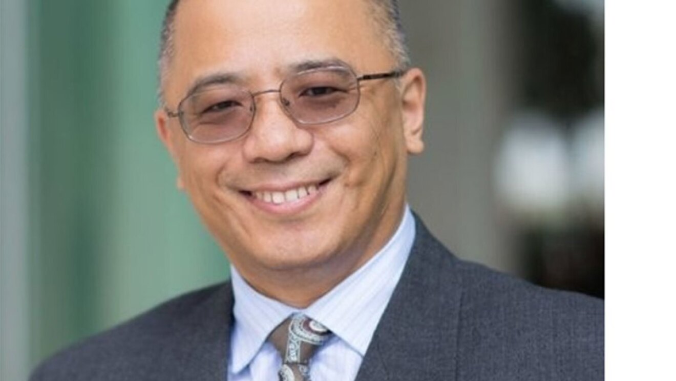 Crop shot of Tommy Jiang in a suit and tie