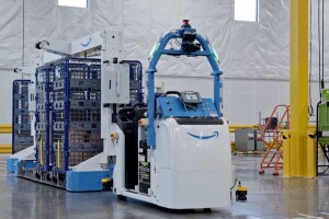 An image of a large robotic device pulling carts at an Amazon fulfillment center. 