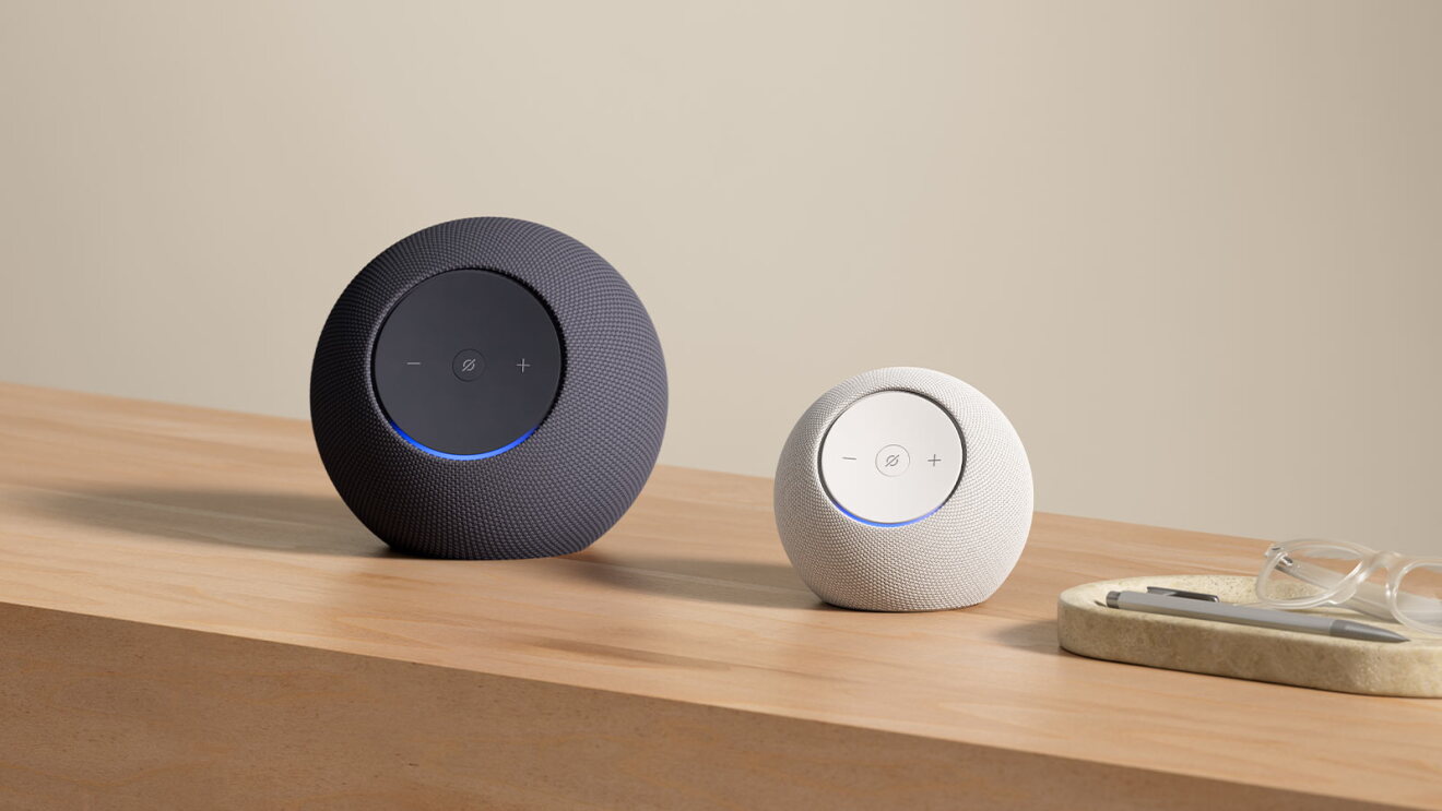 Echo Dot Max and Echo Studio on a wooden table next to a tray holding glasses