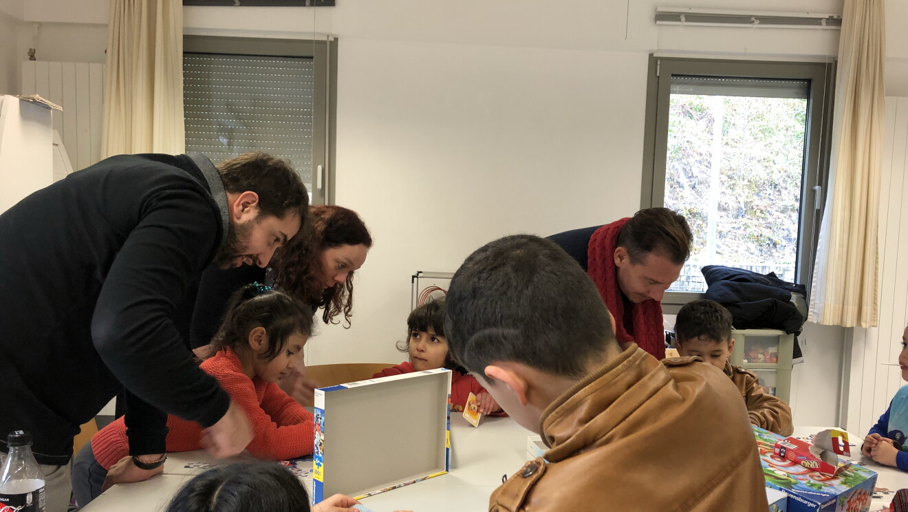 Amazonians play board games with the children at Marianthel Foyer, a Luxembourg refugee camp