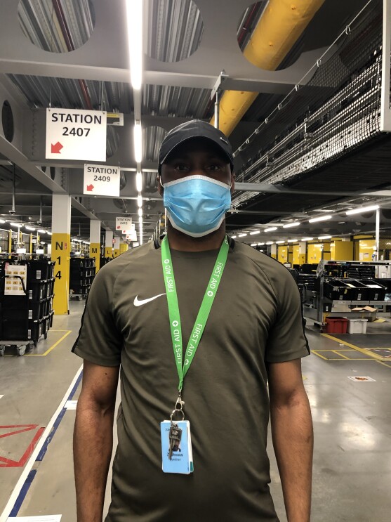 Amazon employee wearing a lanyard looking directly at the camera