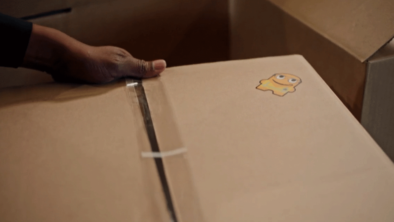 A close-up image of an Amazon box with a sticker on it.