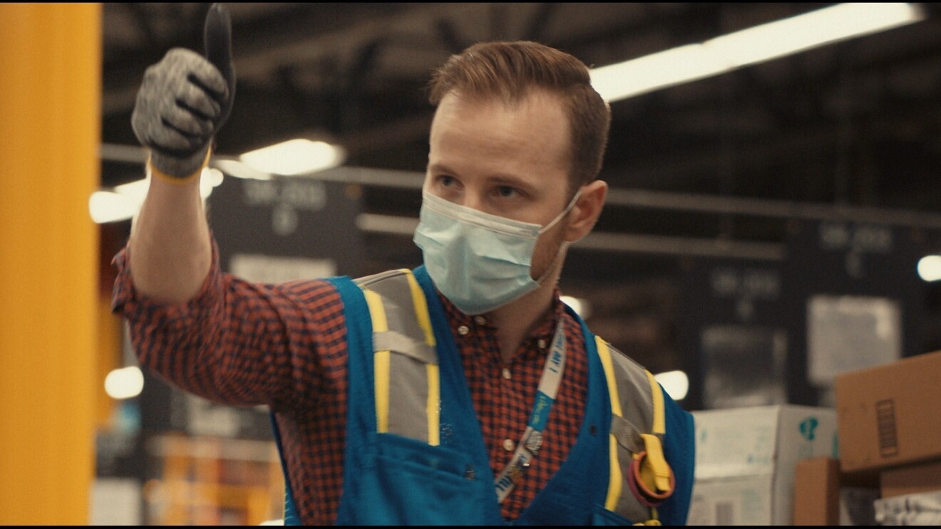 Amazon employee with thumb up and wearing mask