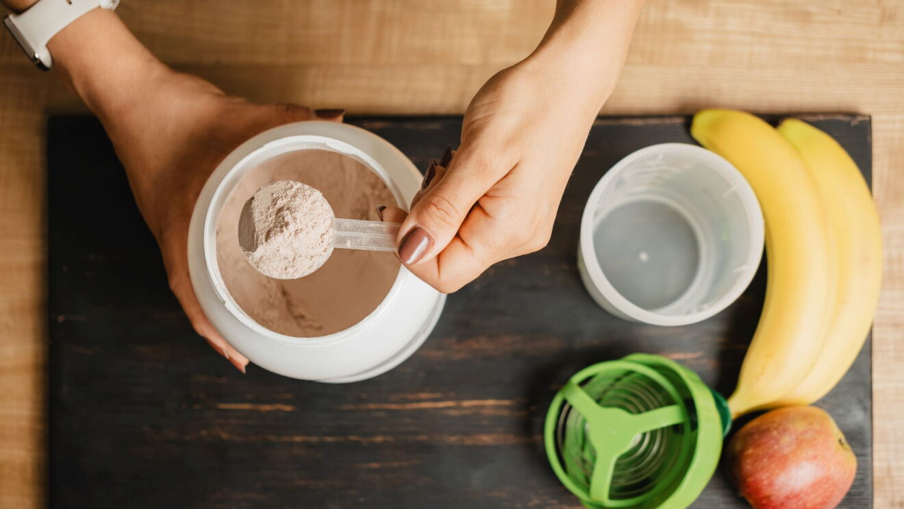 Fitness nutrition setup with fruits and protein powder.