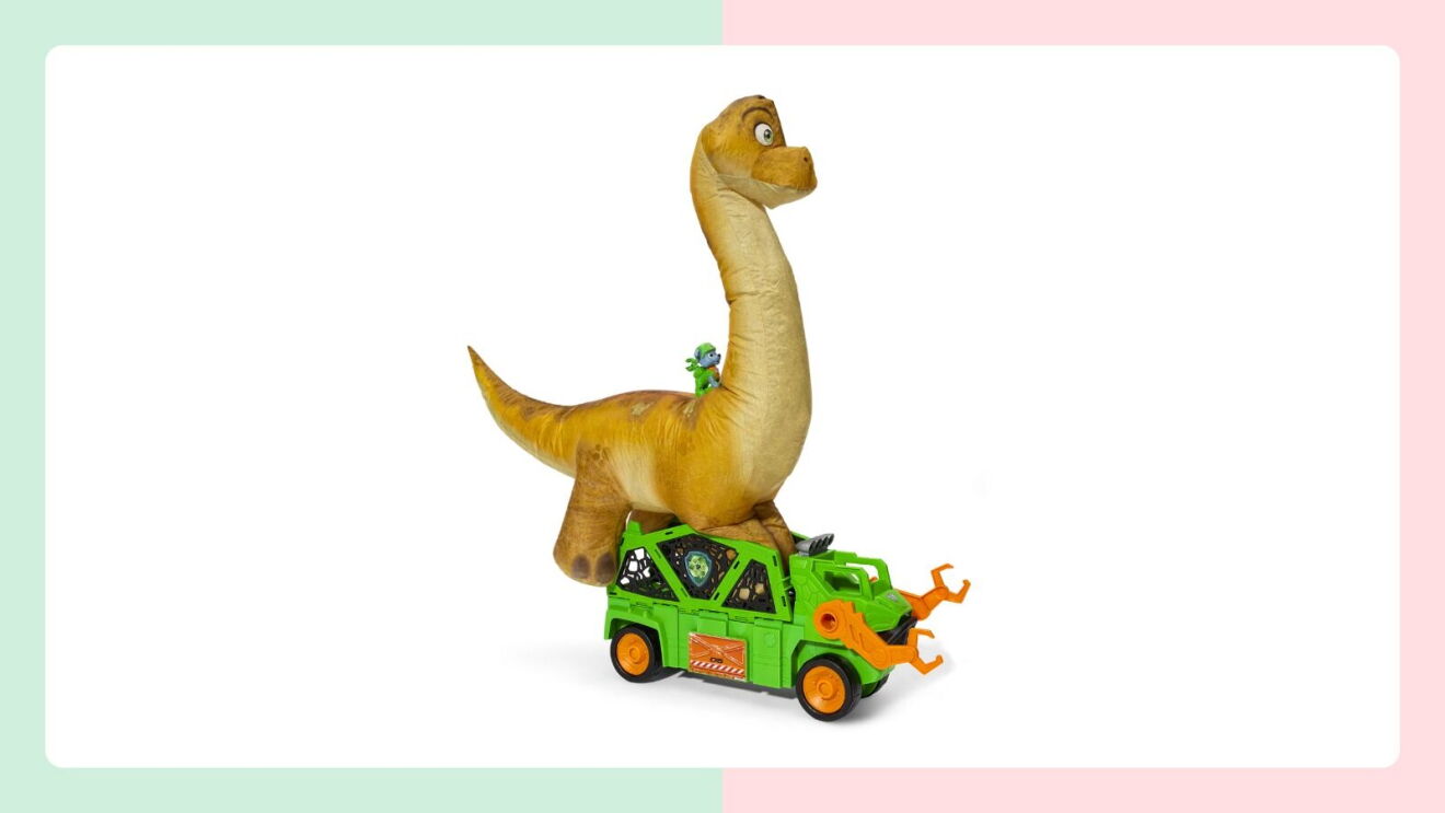 Plush brachiosaurus toy standing on a green rescue vehicle with orange claw arms