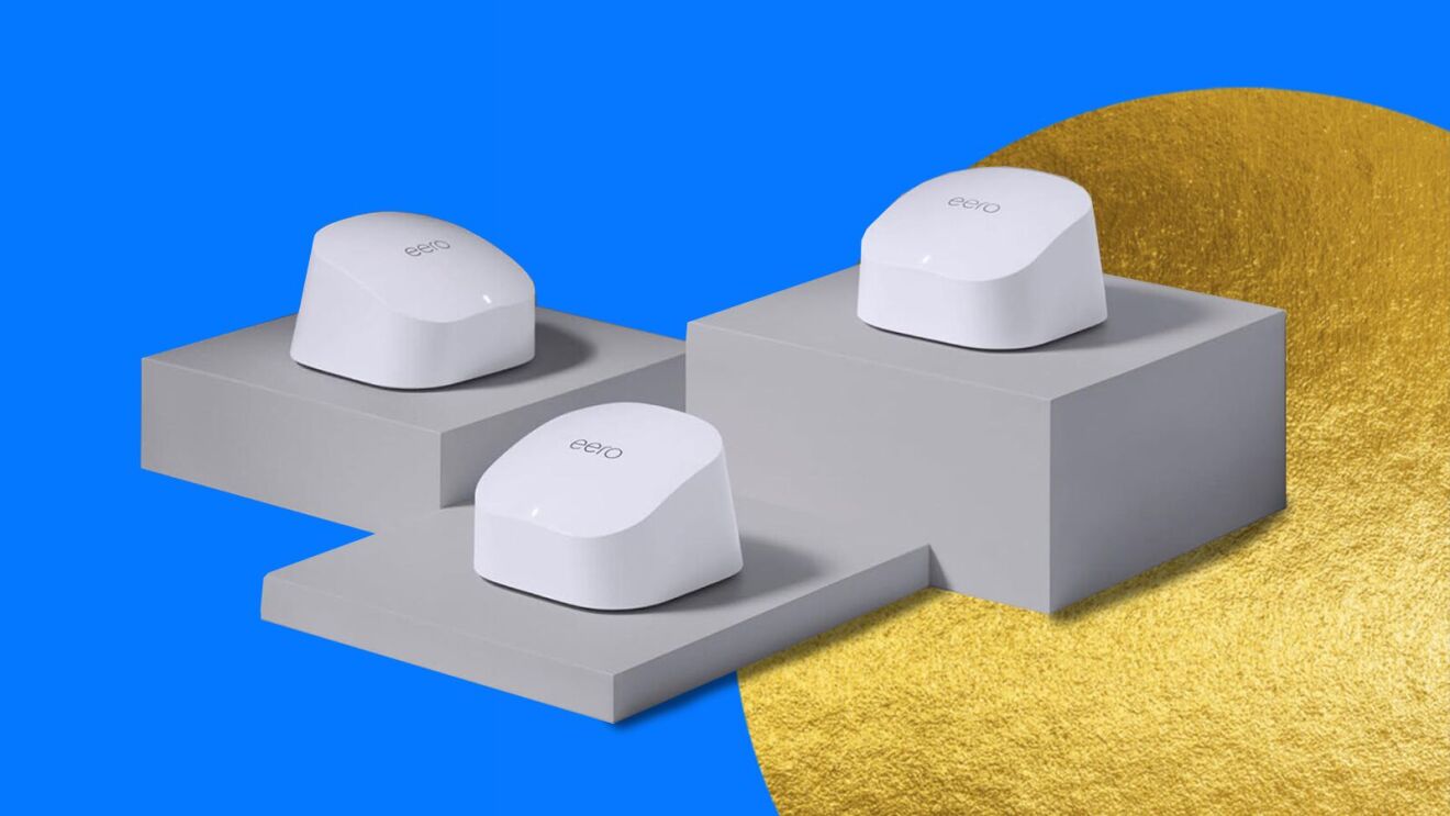 Three white Eero mesh WiFi routers on gray pedestals against blue and gold background