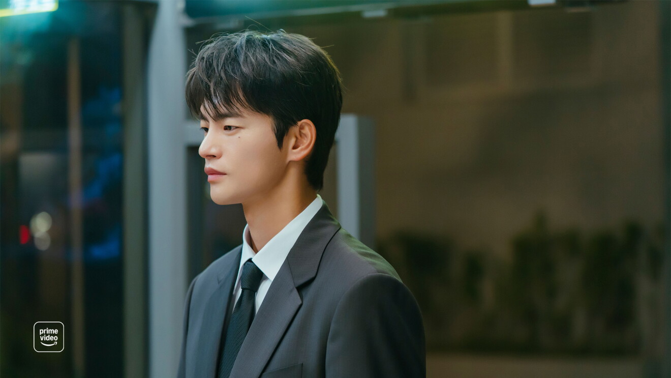 Young man in business suit with tie looking to the side in profile