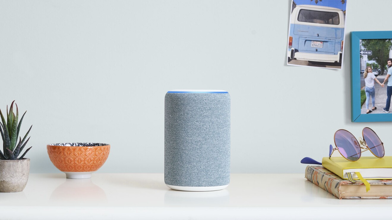 Alexa device sat on top of white desk 