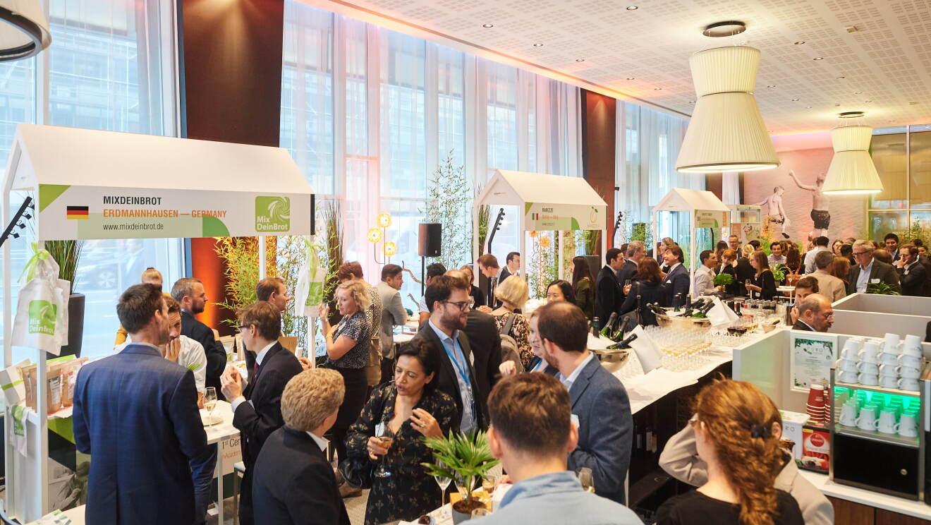 Amazon Academy Marketplace Exhibition, numerous people standing and tasting delicacies from different small brands selling on Amazon. 
