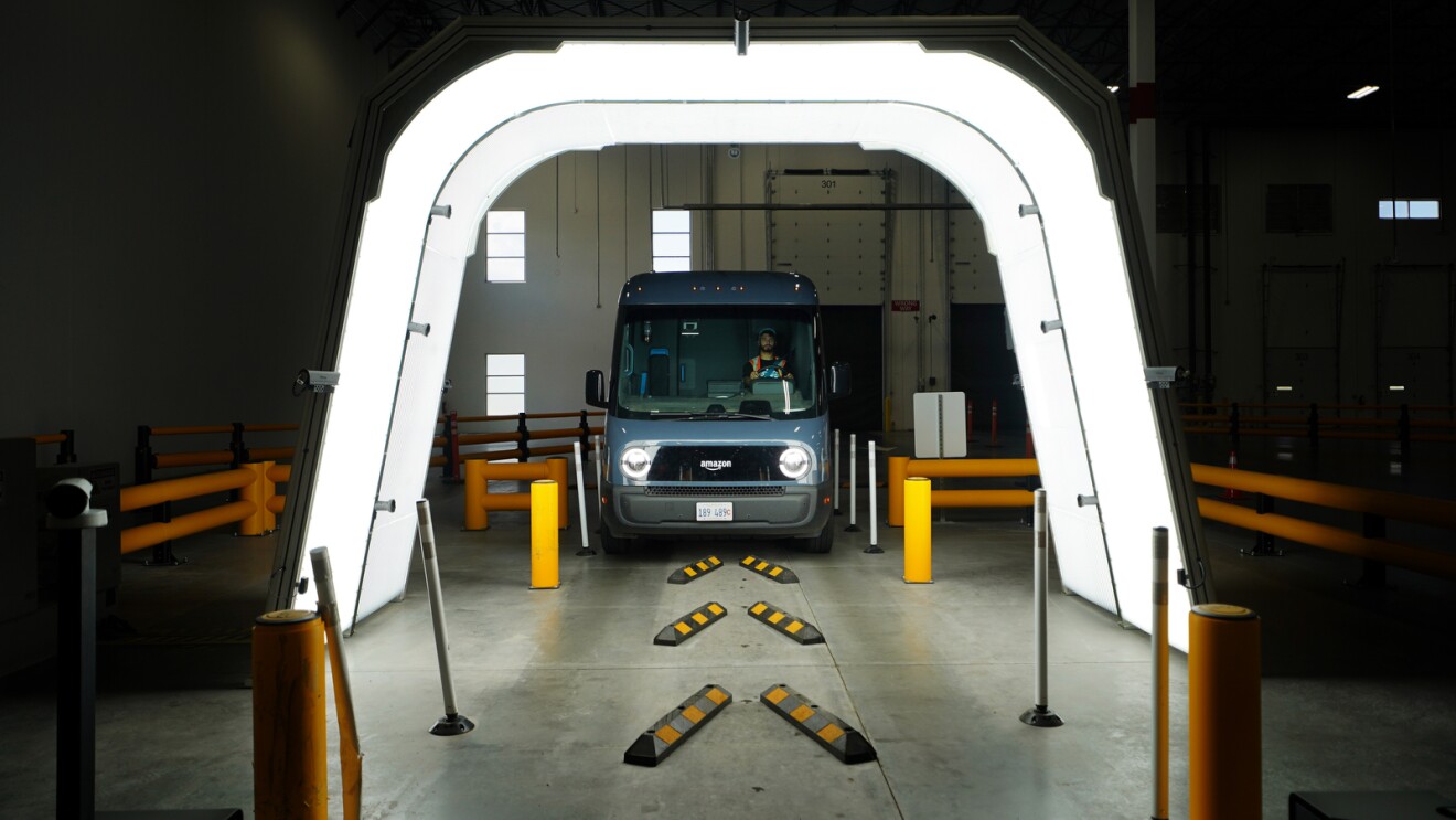 An image of an Amazon delivery van receiving an artificial intelligence (AI)–based technology scan that can spot even the smallest anomalies