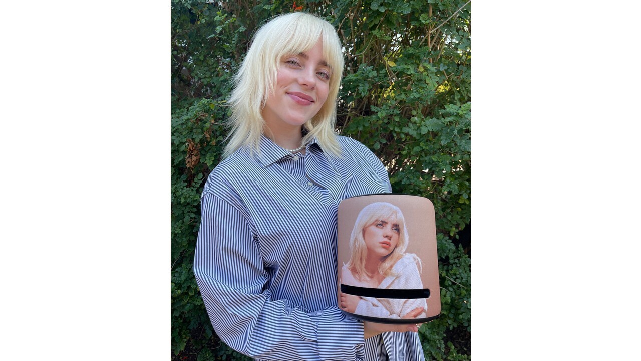 Billie Eilish holds the limited edition Amazon Echo with her face as the design.