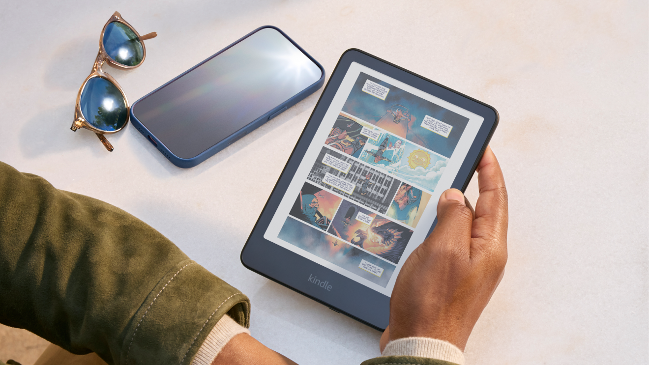 A man reading a colour comic book on a Kindle Colorsoft