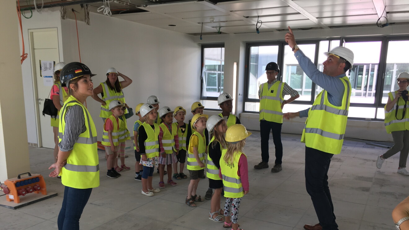 Children wearing vests and helmets at the tour of Amazon EU HQ in Luxembourg