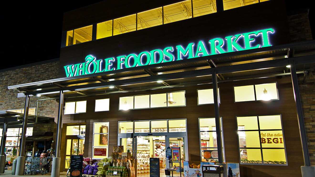 A photo of a Whole Foods Market storefront at night