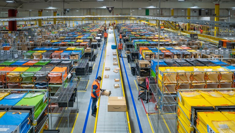 Photos of Amazon associates working in a Fulfillment Center in France.