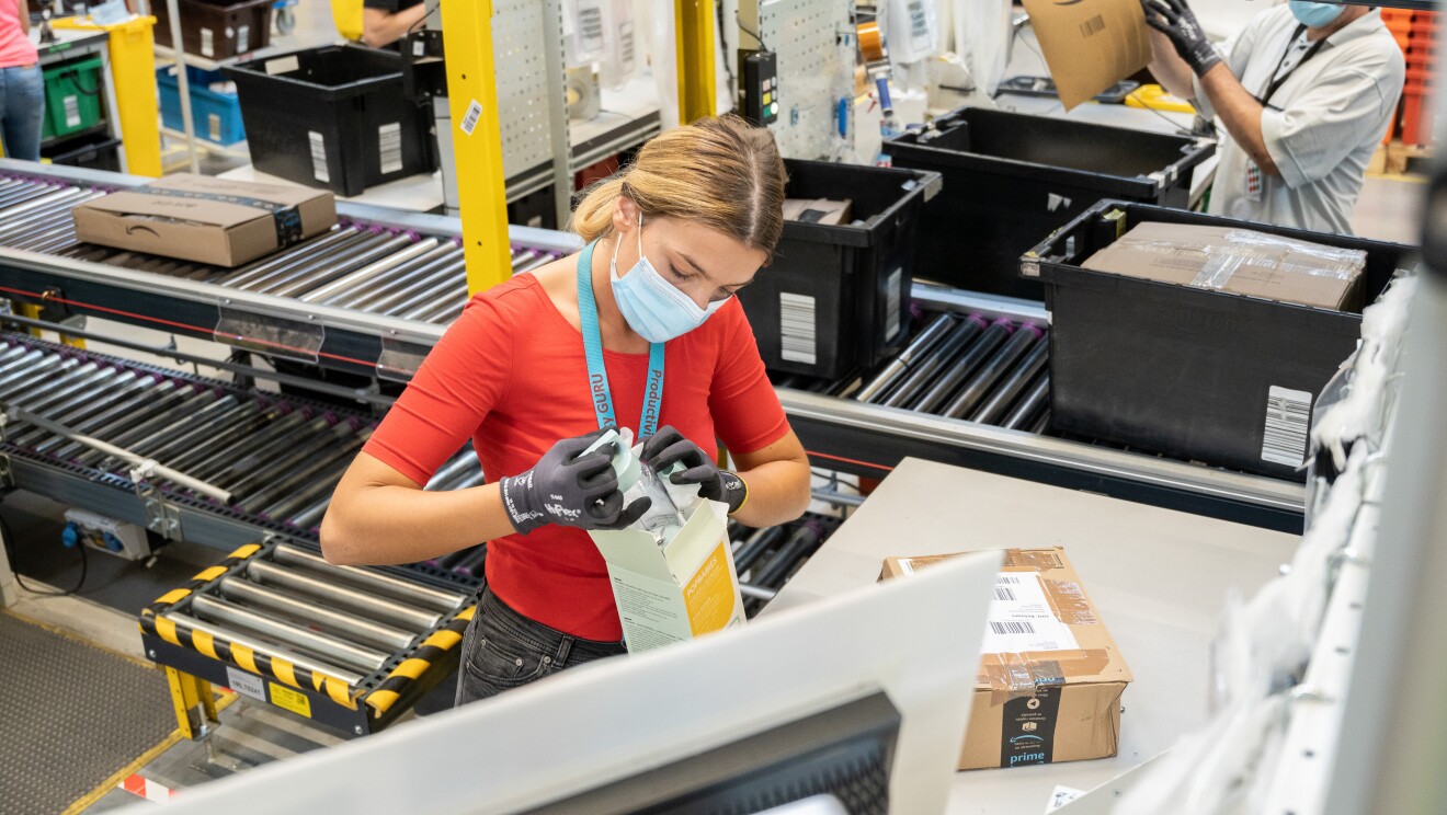 amazon employee inspects returned products at fulfilment centre