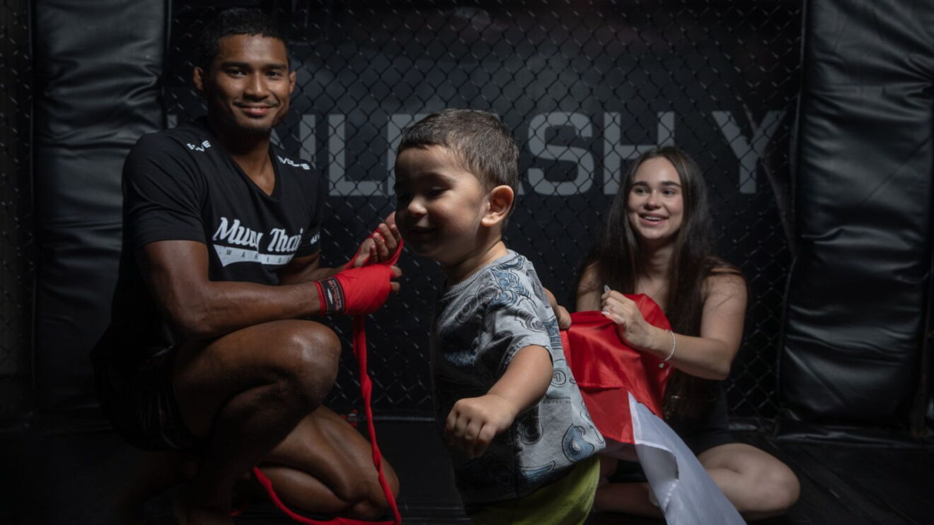 MMA fighter Amir Khan with his wife and child.