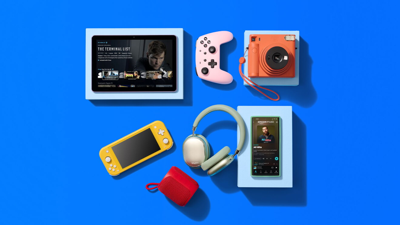 Modern tech gadgets arranged on vibrant blue background