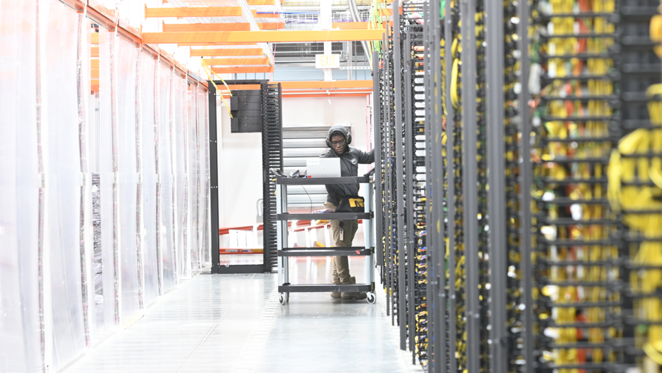 A phot of an AWS data technician working in a data center.