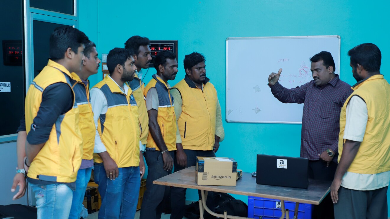 Service Partner speaking with his associates in his office