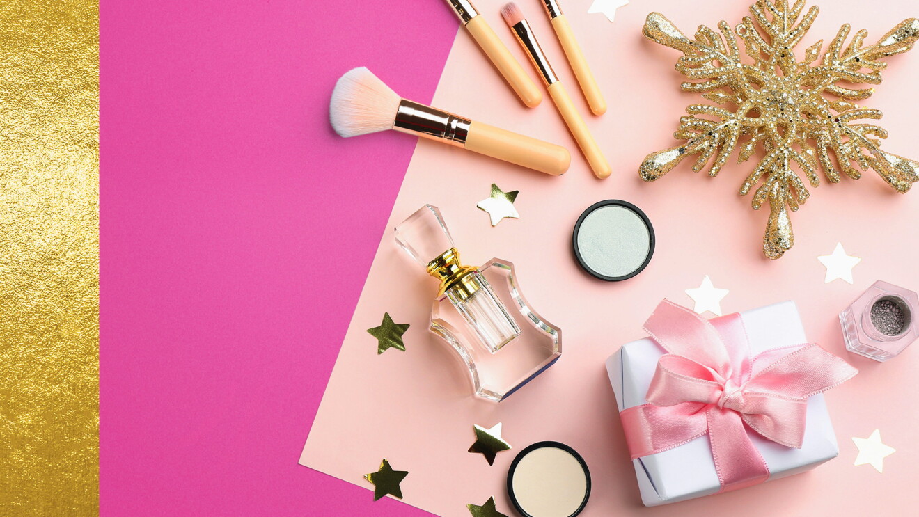 Beauty products on pink and gold background 