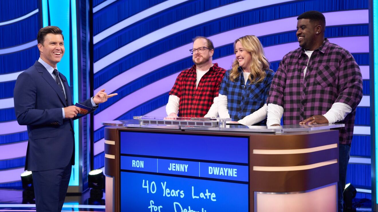 TV quiz show set with blue and purple striped background.
