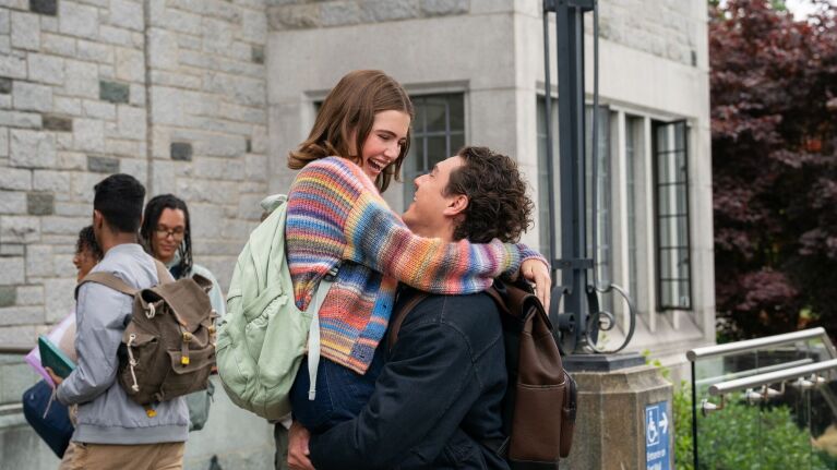 A woman and a man smile at each other