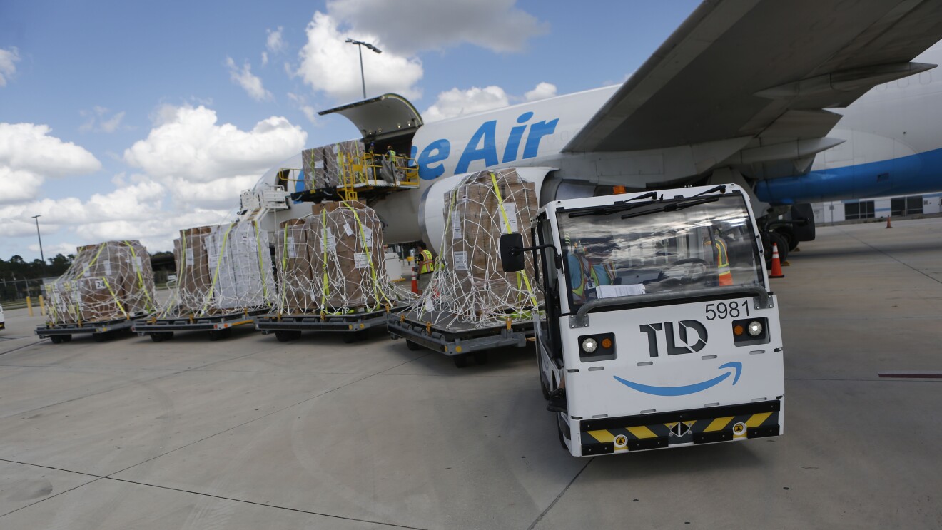 Cargo being loaded onto Prime Air plane with Amazon TLD vehicle in foreground for DRbA for Hurricane Milton