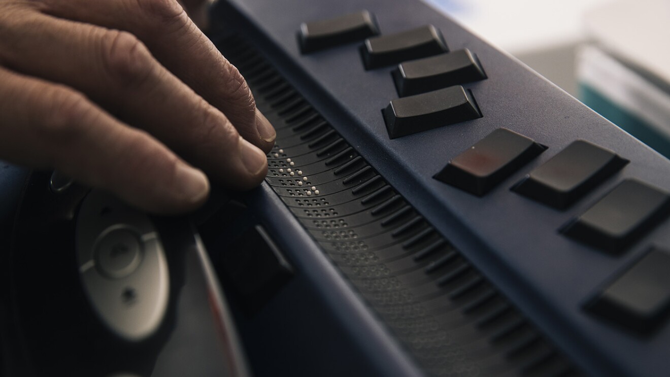Josh Miele, Principle Accessibility Researcher at Amazon Lab126, uses a refreshable braille display in his home office.