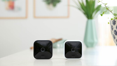 Two Blink indoor/outdoor cameras on a countertop.