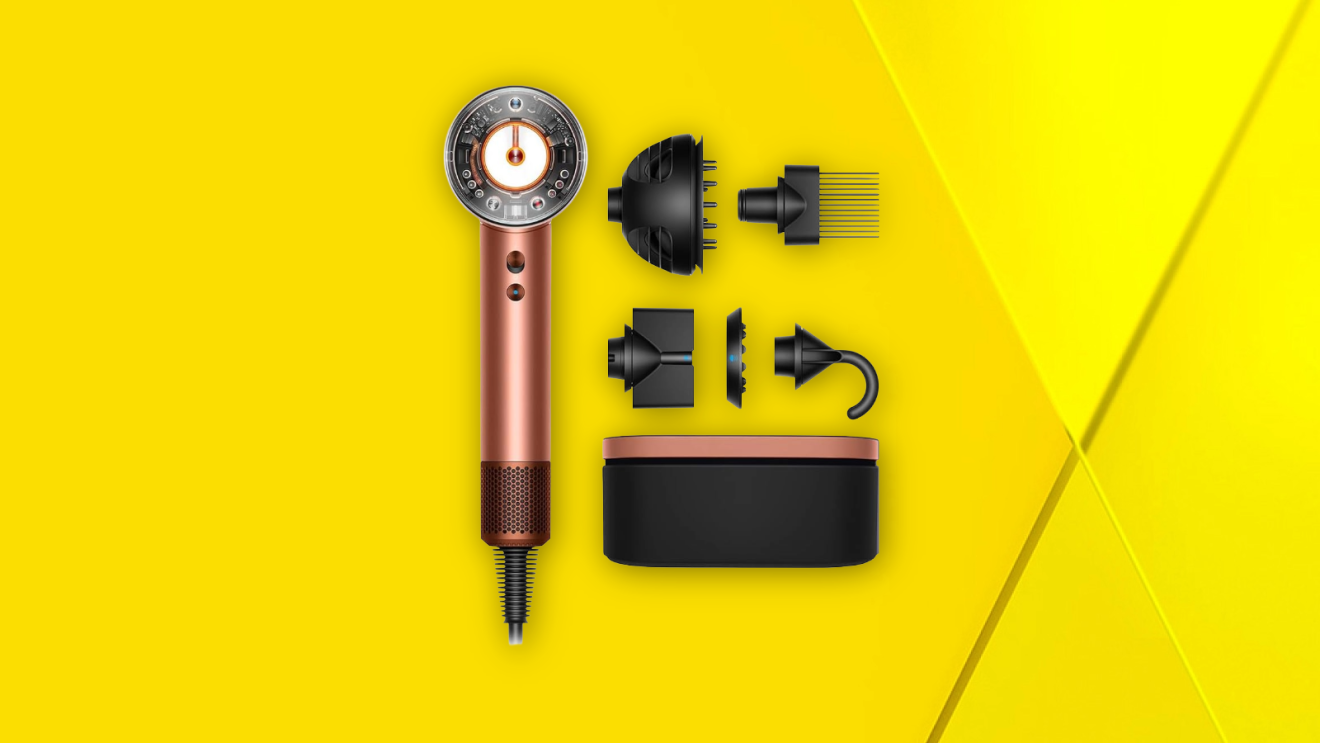 Rose gold Dyson hair dryer with five black styling attachments and storage case on yellow background