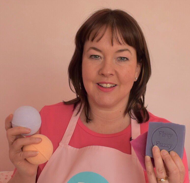 vicki from Fizzy Fuzzy holding bath bombs